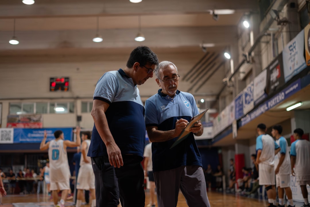 Basketball coaches discuss strategy on the court.