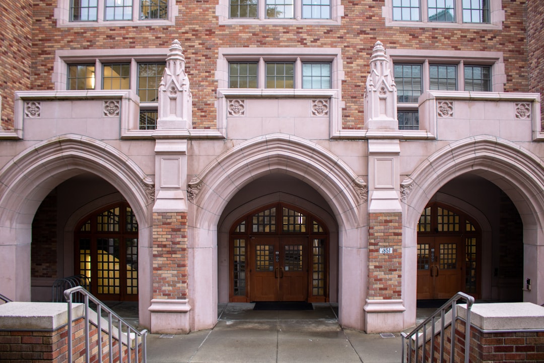 Brick building entrance with three arched doorways.
